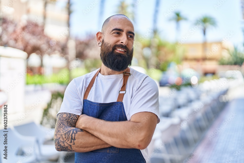 Young bald man waiter smiling confident standing with arms crossed gesture at street Young bald man waiter smiling confident standing with arms crossed gesture at street