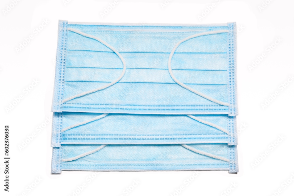 Medical protective masks in blue color isolated on white background Medical protective masks in blue color isolated on white background