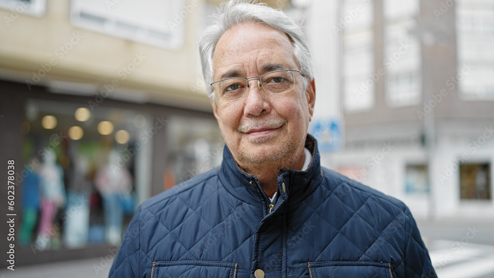 Middle age man with grey hair standing with serious expression at street Middle age man with grey hair standing with serious expression at street
