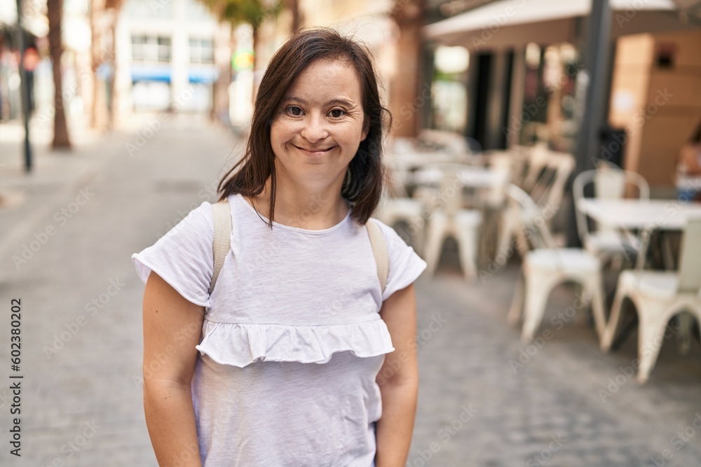 Down syndrome woman smiling confident standing at street Down syndrome woman smiling confident standing at street