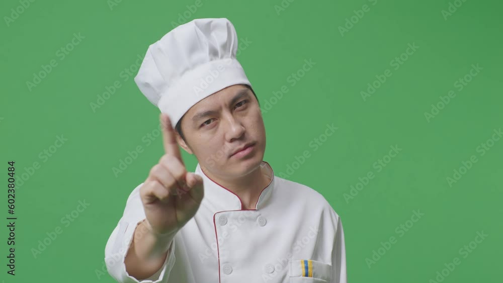 Close Up Of Asian Man Chef Pointing At You And Disapproving With No Index Finger Sign In The Green Screen Background Studio
Close Up Of Asian Man Chef Pointing At You And Disapproving With No Index Finger Sign In The Green Screen Background Studio