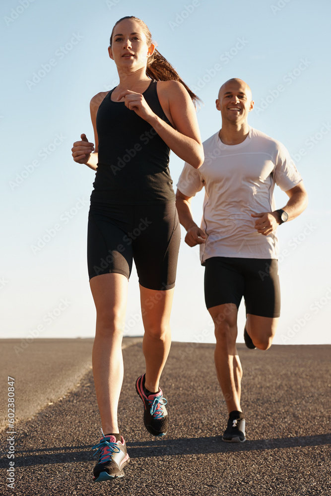 Fototapeta premium Road, training and personal trainer running with woman as workout or morning exercise for health and wellness. Sport, man and street runner with athlete as fitness for a marathon, sports and energy