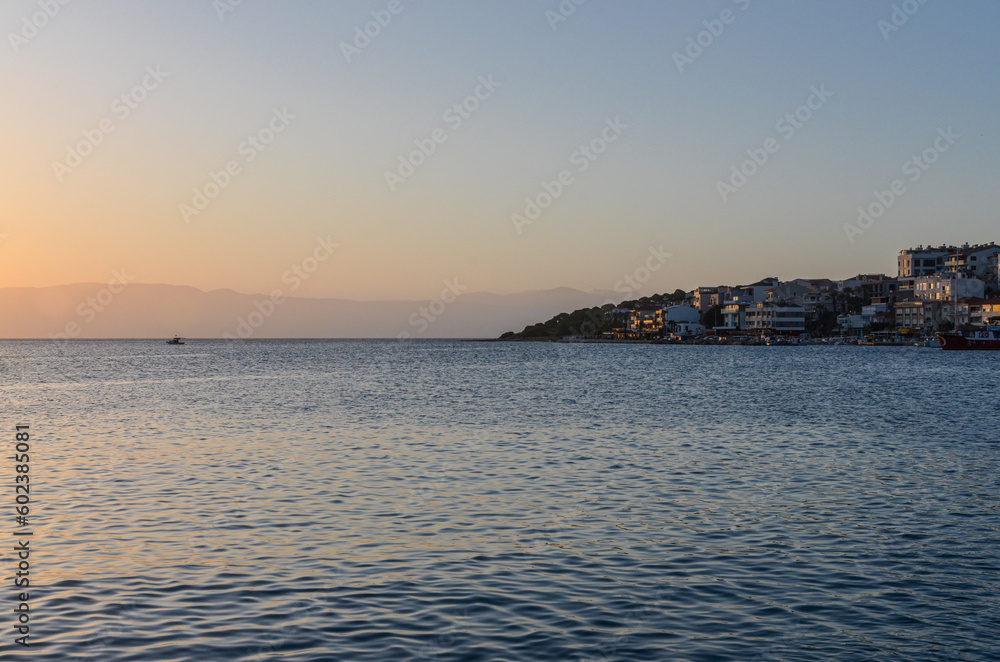 scenic view of Cesme harbor and coast at sunset (Izmir province, Turkiye) 
