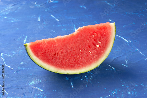 Cut watermelon on blue background.