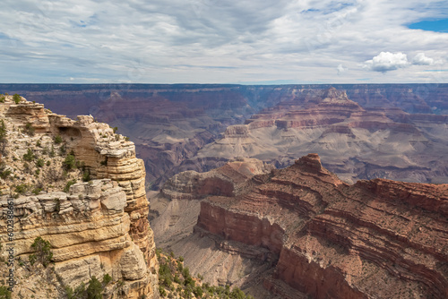 Massive rock formation with panoramic view of O Neill Butte seen from South Kaibab hiking trail at South Rim of Grand Canyon National Park, Arizona, USA. Colorado River weaving through rugged terrain