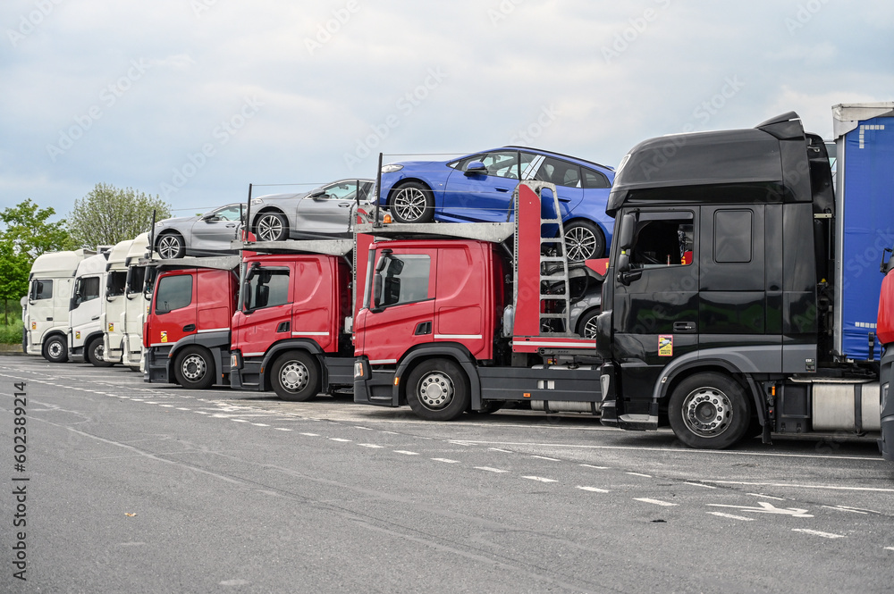 A group of trucks in a parking lot at a gas station. Drivers are resting. Transport by trucks. A group of trucks in a parking lot at a gas station. Drivers are resting. Transport by trucks.