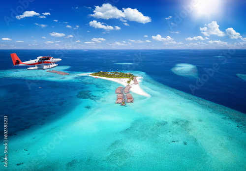 Exotic travel concept with a aerial view of a seaplane approaching a tropical paradise island in the Maldives, Indian Ocean