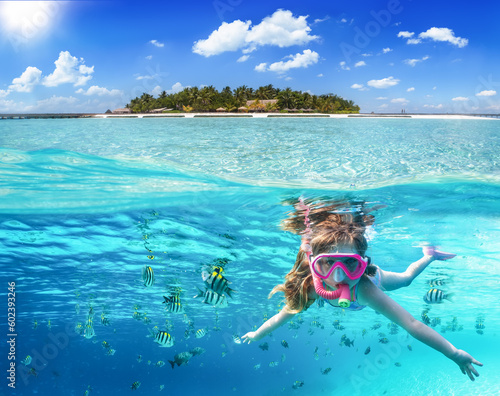 Photography Split image with a tropical island and underwater life with a girl snorkeling in