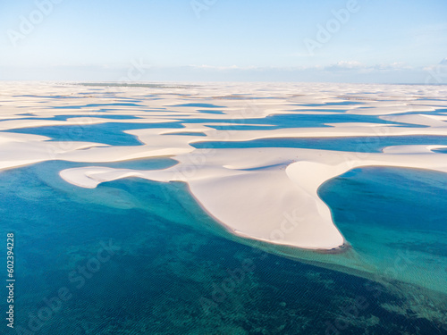 Drone shot of fresh rain water lagoons with white sand dunes at Lençóis maranhenses national park in Brazil photo