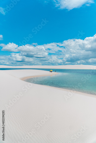 Blue fresh water lagoon with white sand at Lençóis maranhenses national park Brazil