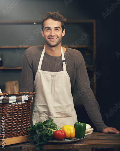 Chef, smile and portrait of man in kitchen with vegetables for vegetarian meal, healthy diet or vegan nutrition. Cooking, happiness and confident male cook from Canada in restaurant or small business