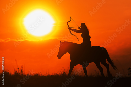 silhouette of a rider with a horse and a bow against the sunset