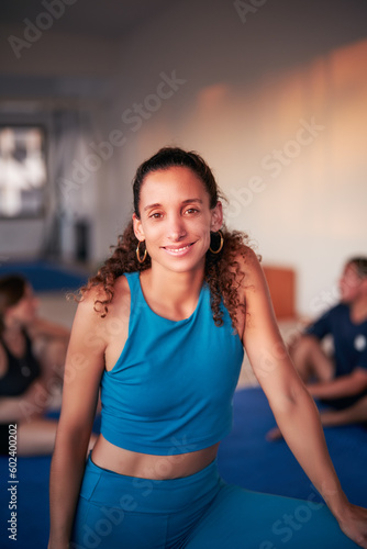 waist up portrait beautiful mid adult latina cheerful sporty woman in gym interior