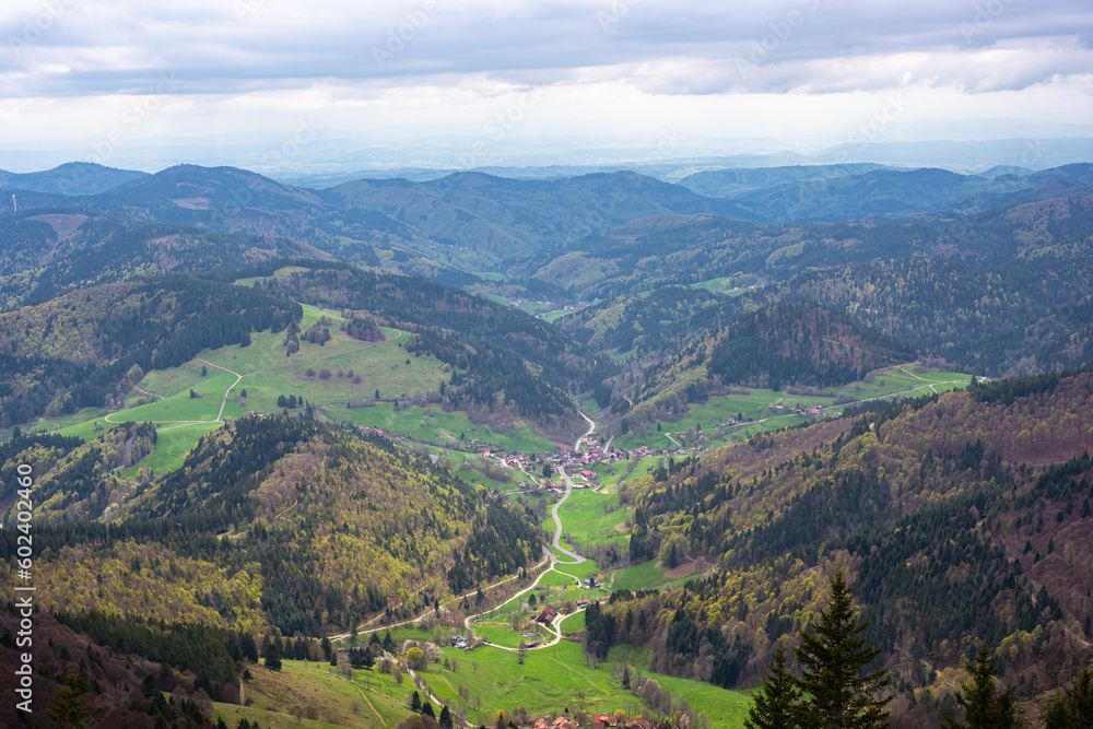 Obraz premium Stunning view of the small village of Böllen in a green valley from Mount Belchen in Black Forest (Schwarzwald), Germany