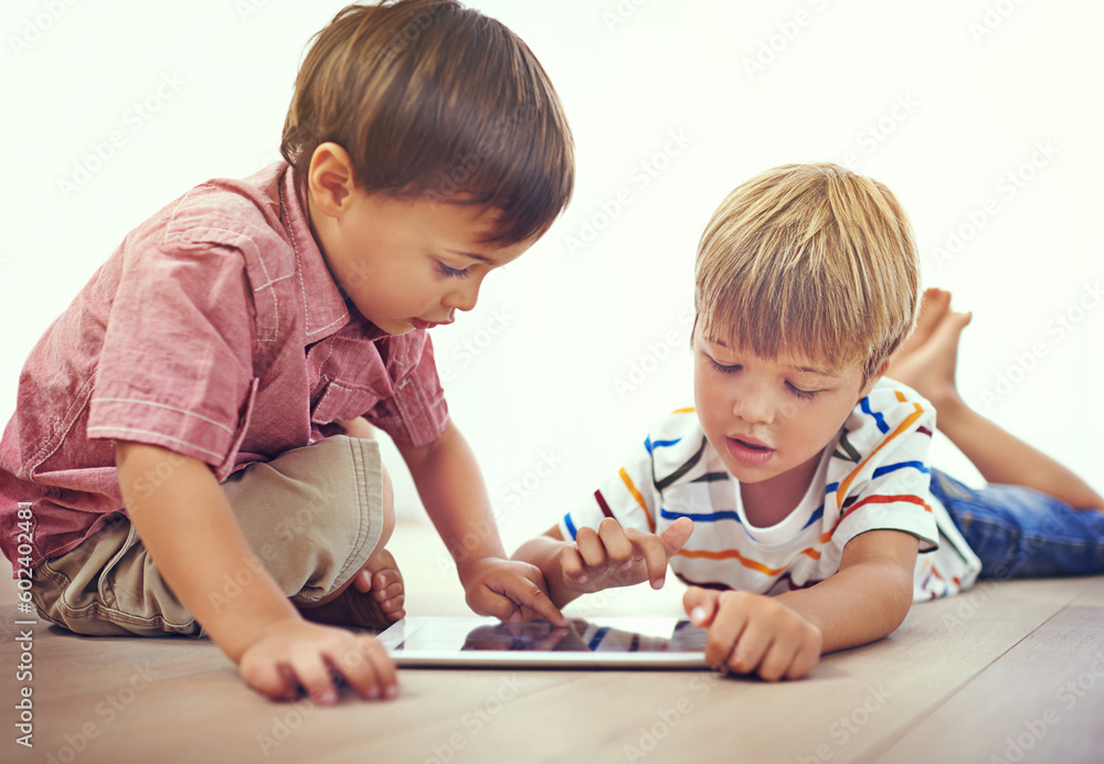 Tablet, learning and children playing together in family home for fun and education. Male kids or friends on floor to play and streaming internet for development with app, game and online video Tablet, learning and children playing together in family home for fun and education. Male kids or friends on floor to play and streaming internet for development with app, game and online video