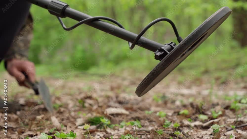 demining the territory of Ukraine. A man checks a forest trail with a metal detector. demining the territory of Ukraine. A man checks a forest trail with a metal detector.
