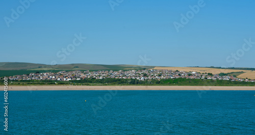 Coastline near Bishopstone, Seaford in East Sussex viewed from the sea on a summers day with clear bue sky.