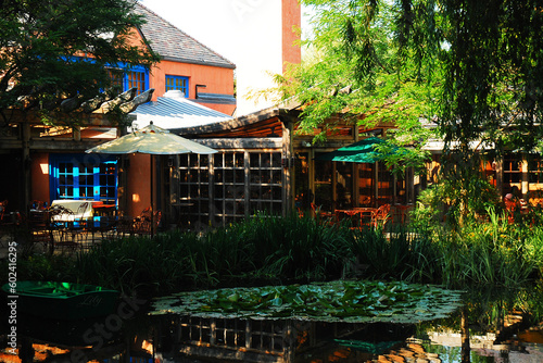 A cafe sits in the center of a sculpture garden at the edge of a pond