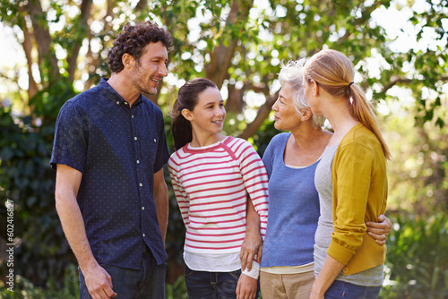 Happy family, parents with kid and grandmother in nature, happiness and freedom outdoor in park together. Love, trust and support with people spending quality time outside with care and generations