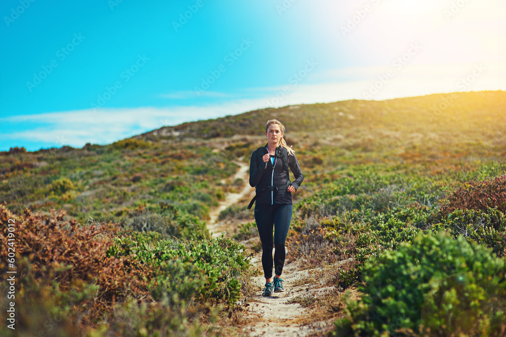 Woman running through field, fitness outdoor with cardio and training for marathon with young athlete and sports. Female runner in nature, hiking trail and run for exercise, healthy and active person
