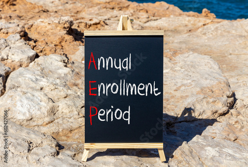 AEP symbol. Concept words AEP Annual enrollment period on beautifulblack chalk blackboard. Beautiful stone beach blue sea background. Medical and AEP Annual enrollment period concept. Copy space. photo