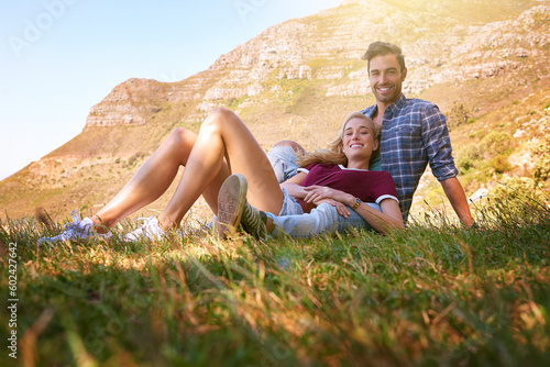 Relax, love and portrait of couple in nature for carefree, bonding and affectionate. Happiness, date and romance with man and woman cuddle in grass field for summer break, happy and mountains © Anne B/peopleimages.com