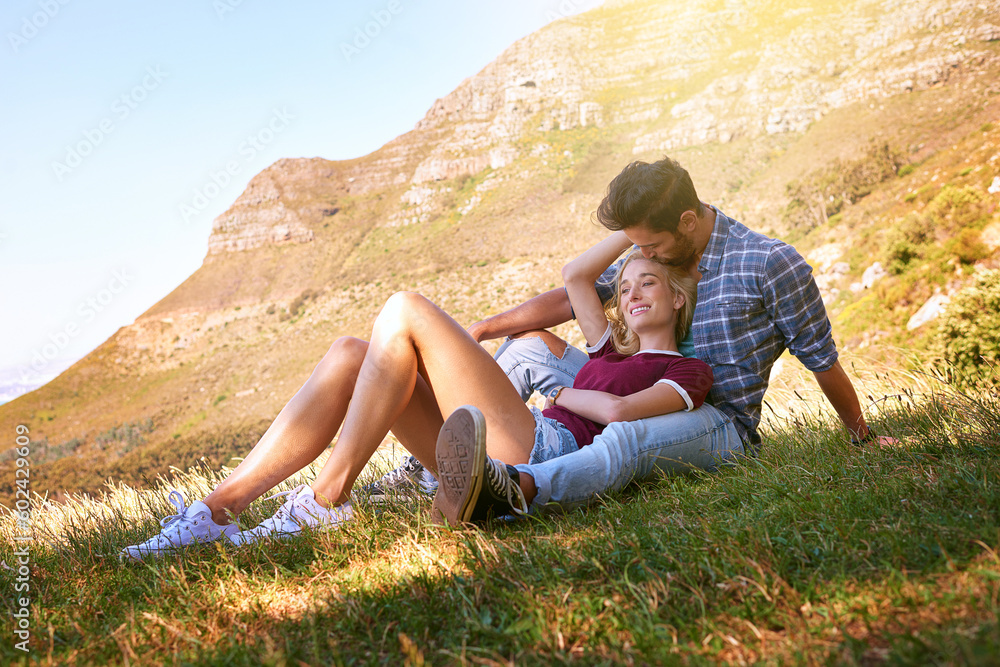 Relax, kiss and happy with couple in nature for carefree, bonding and affectionate. Happiness, date and romance with man and woman cuddle in grass field for summer break, love and mountains Relax, kiss and happy with couple in nature for carefree, bonding and affectionate. Happiness, date and romance with man and woman cuddle in grass field for summer break, love and mountains