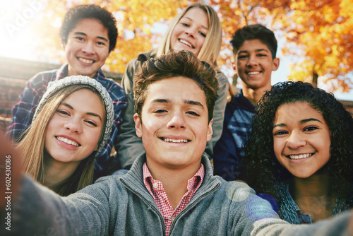 Selfie, teenager and group of friends in park, nature or fall trees and teens smile, picture of friendship and happiness for social media. Portrait, face and happy people together for autumn photo