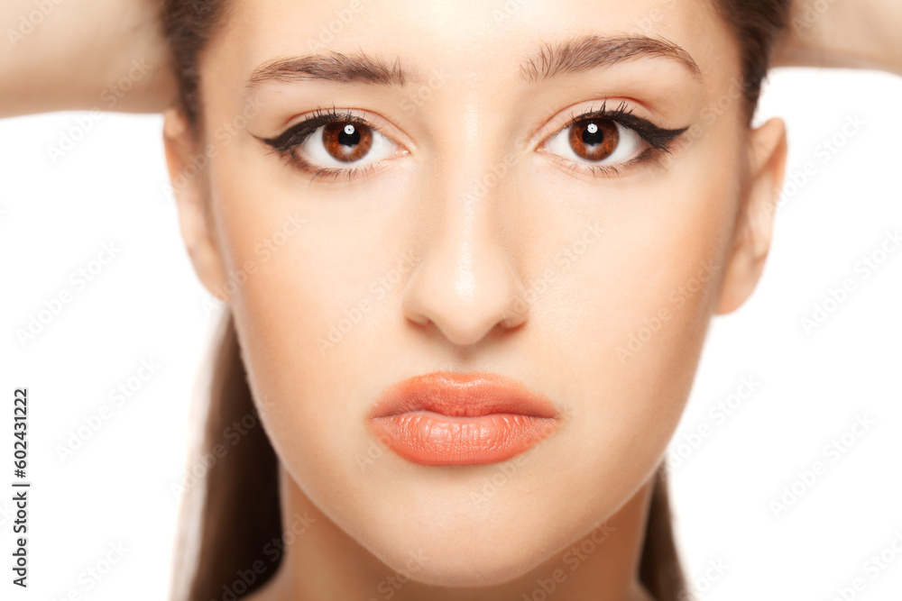 Fototapeta premium Beautiful girl close up studio portrait against white background.