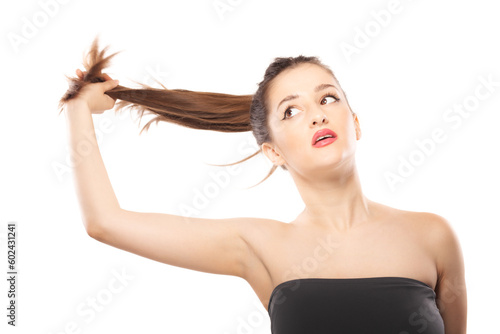 Beautiful girl close studio portrait against white background. Holding hair in the air.