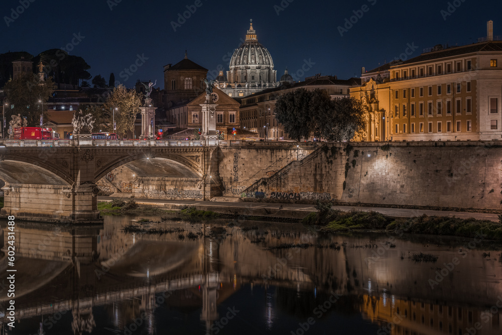 Scenic night cityscape of Rome with the illuminated cupola of St. Peter Basilica, Italy