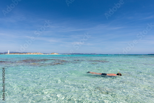 Man snorkelling in clear, turquoise water off the islet of s'Espalmador, in Formentera (Balearic Islands, Spain)