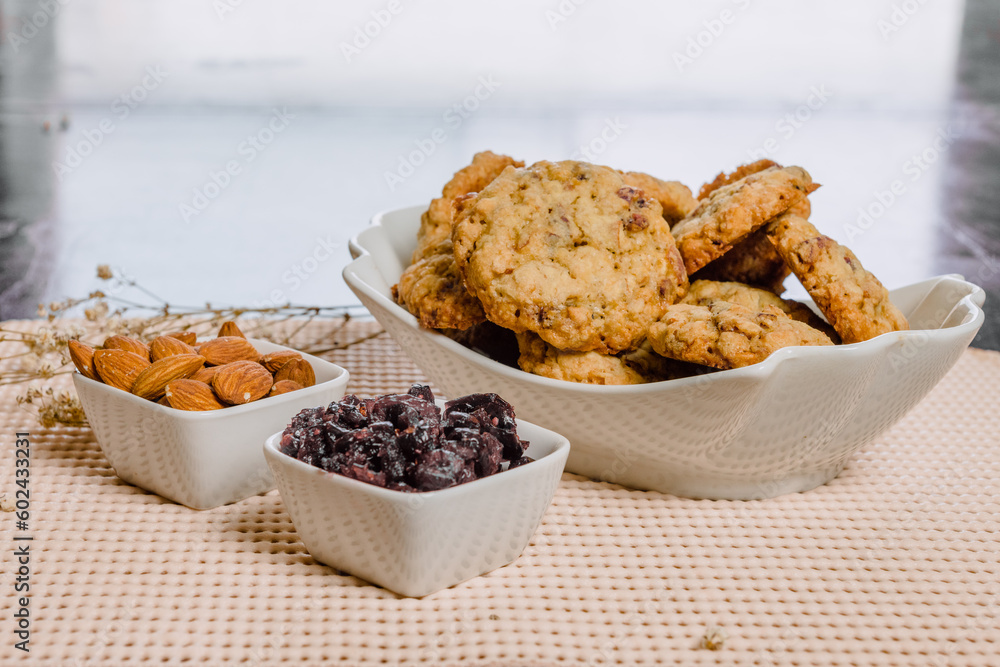 Pumpkin, oat cookies with cranberries, almond on a bowl in a kitchen. Pumpkin, oat cookies with cranberries, almond on a bowl in a kitchen.
