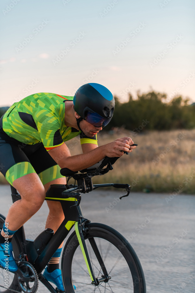 Triathlete riding his bicycle during sunset, preparing for a marathon. The warm colors of the sky provide a beautiful backdrop for his determined and focused effort. Triathlete riding his bicycle during sunset, preparing for a marathon. The warm colors of the sky provide a beautiful backdrop for his determined and focused effort.