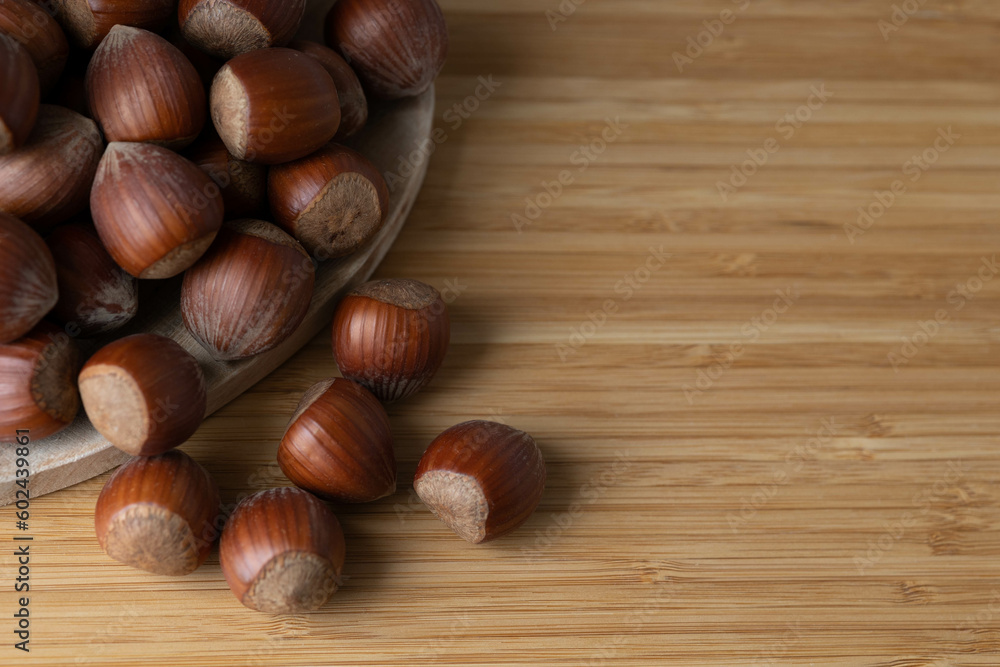 handful of hazelnuts on wooden bowl and wooden table, very healthy nuts handful of hazelnuts on wooden bowl and wooden table, very healthy nuts