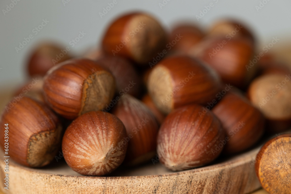handful of hazelnuts on wooden bowl and wooden table, very healthy nuts handful of hazelnuts on wooden bowl and wooden table, very healthy nuts