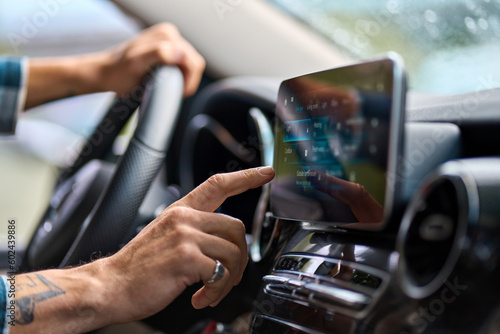 Older man sitting in camper van using gps navigation map system digital device. Smiling mature active traveler driving car vehicle looking at screen touching sensor gadget dashboard, close up view.