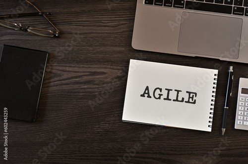 There is notebook with the word AGILE.It is as an eye-catching image.