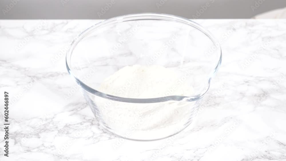 Step by step. Mixing ingredients for mini pancake cereal in a glass mixing bowl. Step by step. Mixing ingredients for mini pancake cereal in a glass mixing bowl.