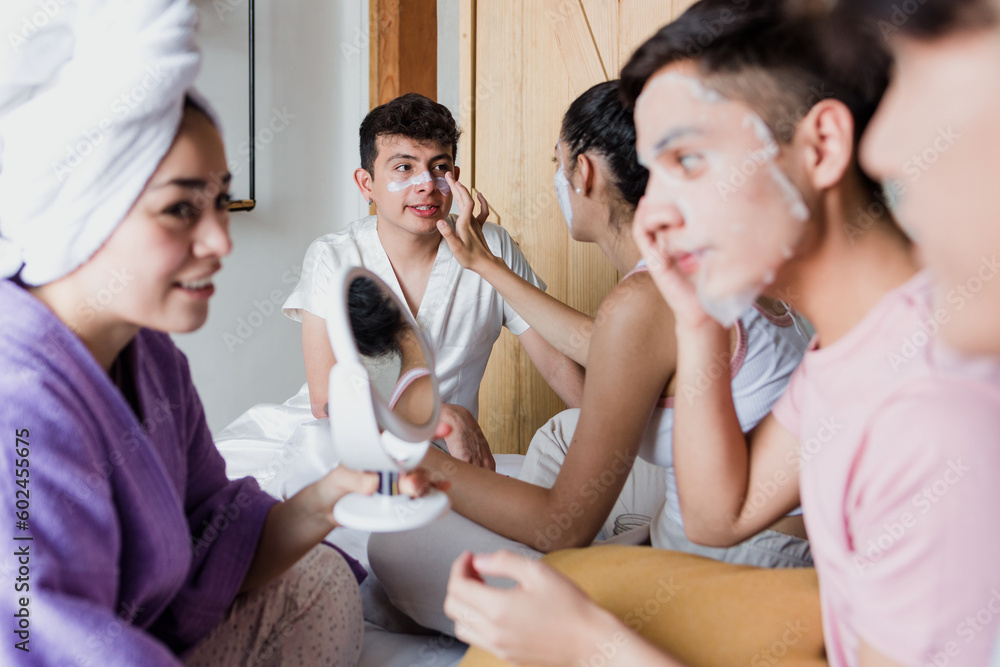 Latin LGBT Friends using Facial mask and cosmetics treatments on bed at home in Mexico, Hispanic homosexual and lgbtq community in Latin America Latin LGBT Friends using Facial mask and cosmetics treatments on bed at home in Mexico, Hispanic homosexual and lgbtq community in Latin America