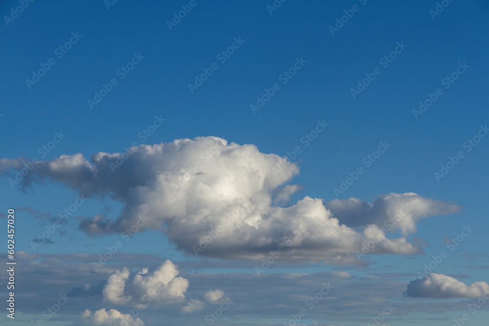 Different clusters with white clouds on blue sky background 
