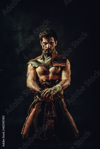 Portrait of an ethnic warrior, kneeling, hands on his saber, gaze on the lens