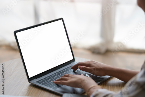 Close Up view shot of woman hands typing on laptop computer keyboard. Blank screen for advertising text.