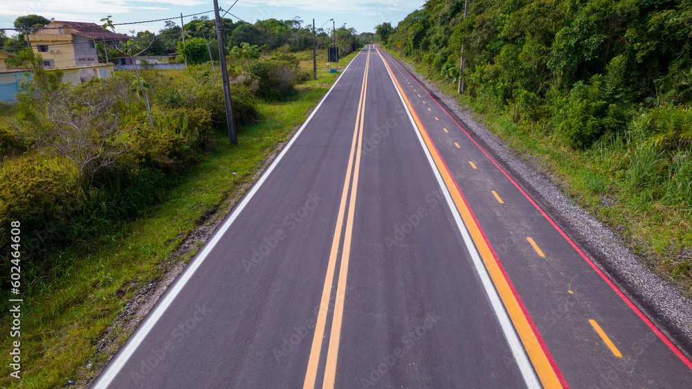 Fototapeta premium Aerial view of the road in the city of Cananéia. Highway in Pariquera Açu
