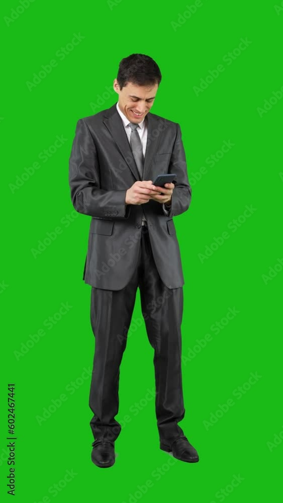 Content businessman writing a message and talking on the phone Content businessman writing a message and talking on the phone