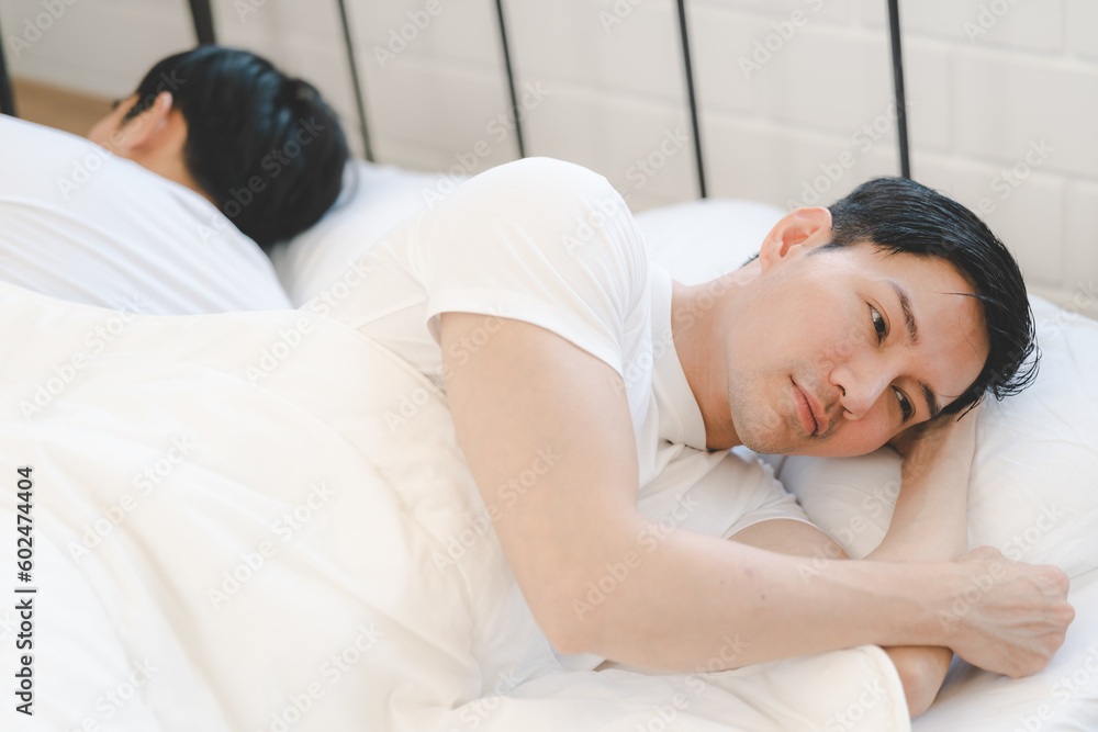 Asian gay couple feeling heartbroken for quarrel conflict and sleep in bedroom. Family problem separation. sad dissatisfied gay couple. Homosexual in problem relationship. Asian gay couple feeling heartbroken for quarrel conflict and sleep in bedroom. Family problem separation. sad dissatisfied gay couple. Homosexual in problem relationship.