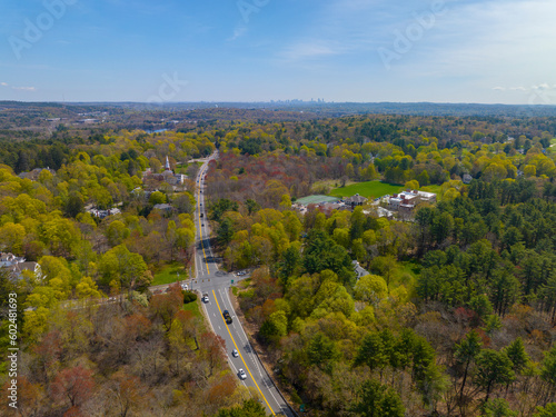 Boston Post Road on US Highway 20 aerial view with Boston Modern city skyline at the background in historic town center of Weston, Massachusetts MA, USA. 