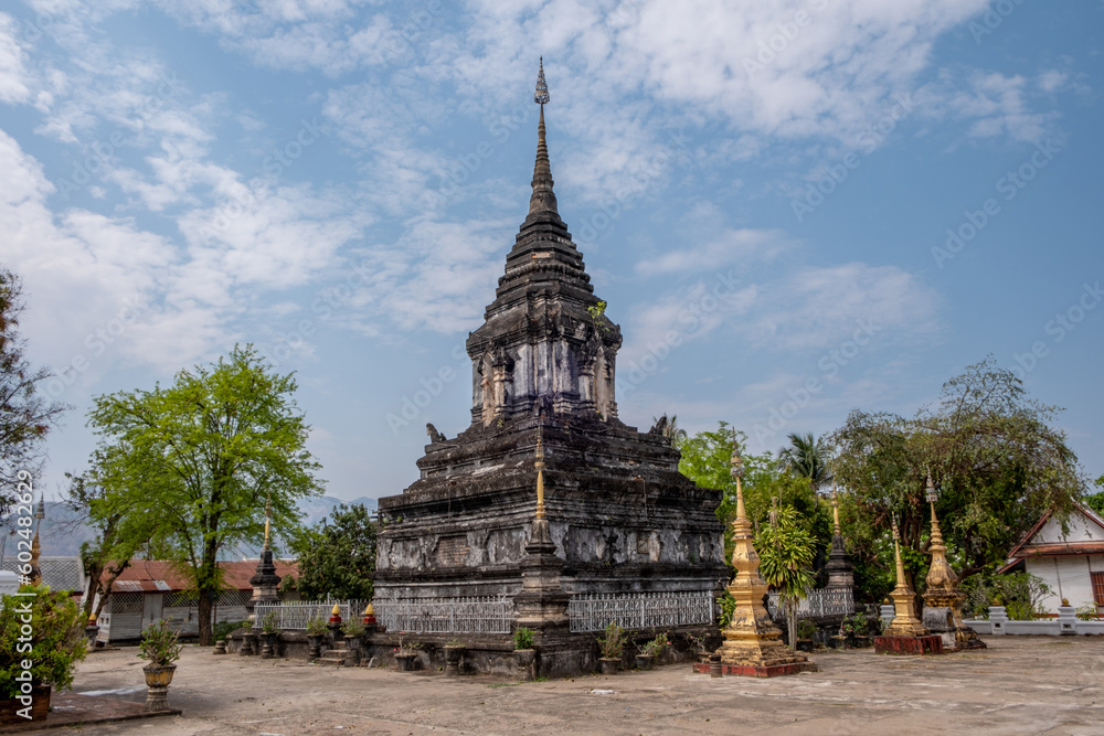 Obraz premium Ancient stupa at Wat Hosian Voravihane Buddhist Temple in Luang Prabang Laos