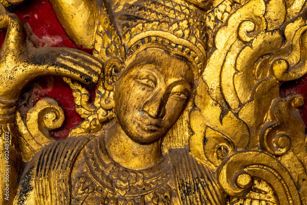 Golden fresco at Wat Hosian Voravihane Buddhist Temple in Luang Prabang Laos