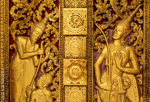 Golden fresco at Wat Hosian Voravihane Buddhist Temple in Luang Prabang Laos photo